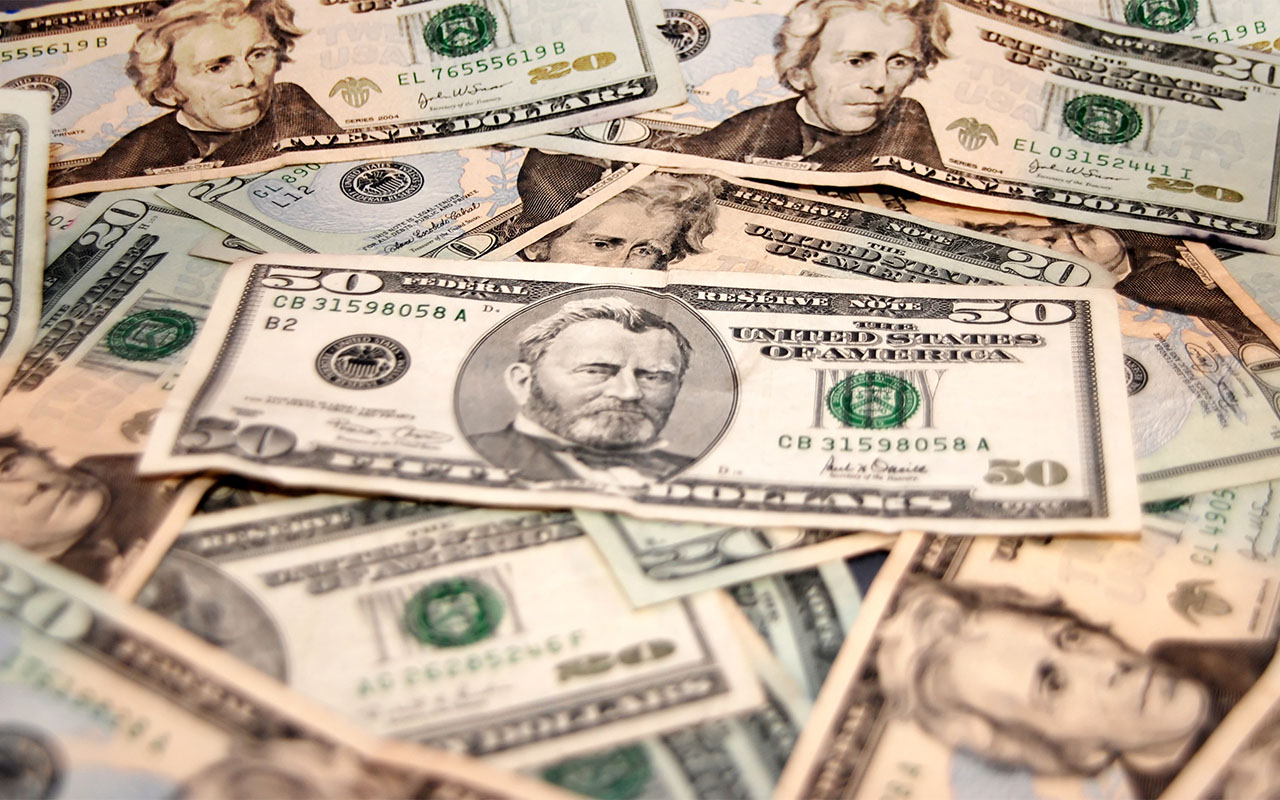 Dollar trims losses after U.S. economic reports